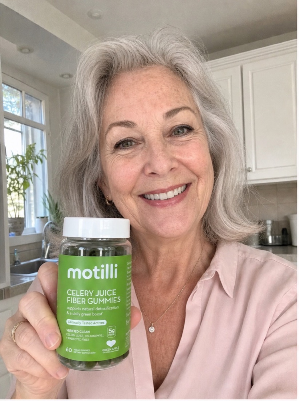Woman holding Motilli celery juice fiber gummies